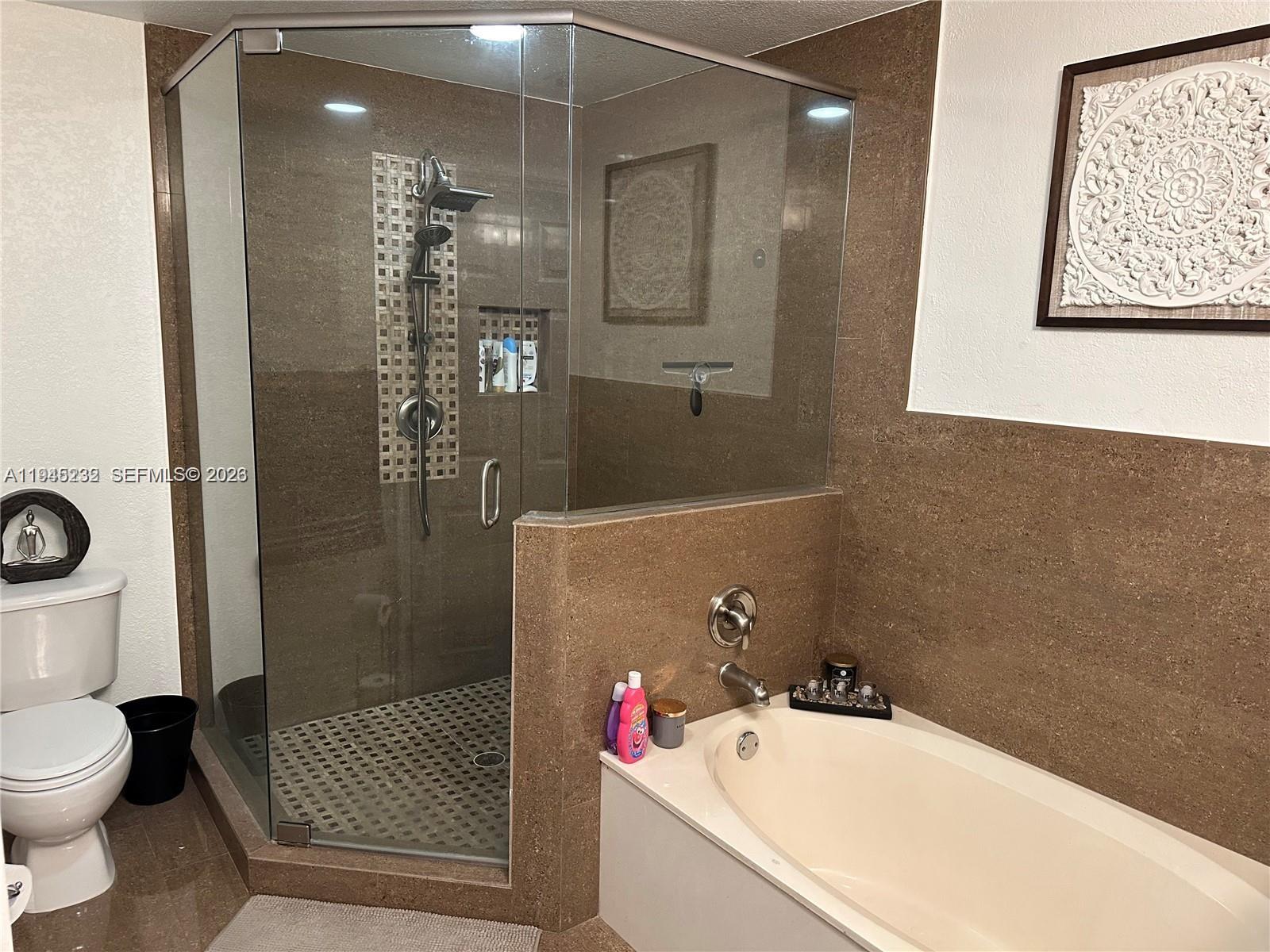 9891 Northwest 24th Street Sunrise, FL 33322 - Photo 5 of 8 a bathroom with a sink a toilet and shower