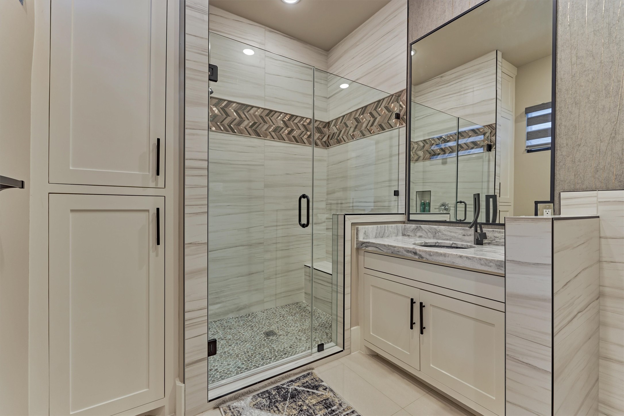 1907 Woerner Road Houston, TX 77090 - Photo 30 of 50 The second full bath in guest's quarters with beautiful tile surround, cabinetry and walk-in shower.