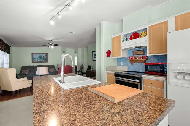 a living room with furniture and a kitchen view