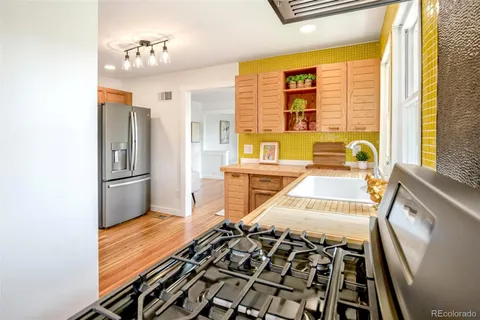 a kitchen with stainless steel appliances a stove and a refrigerator