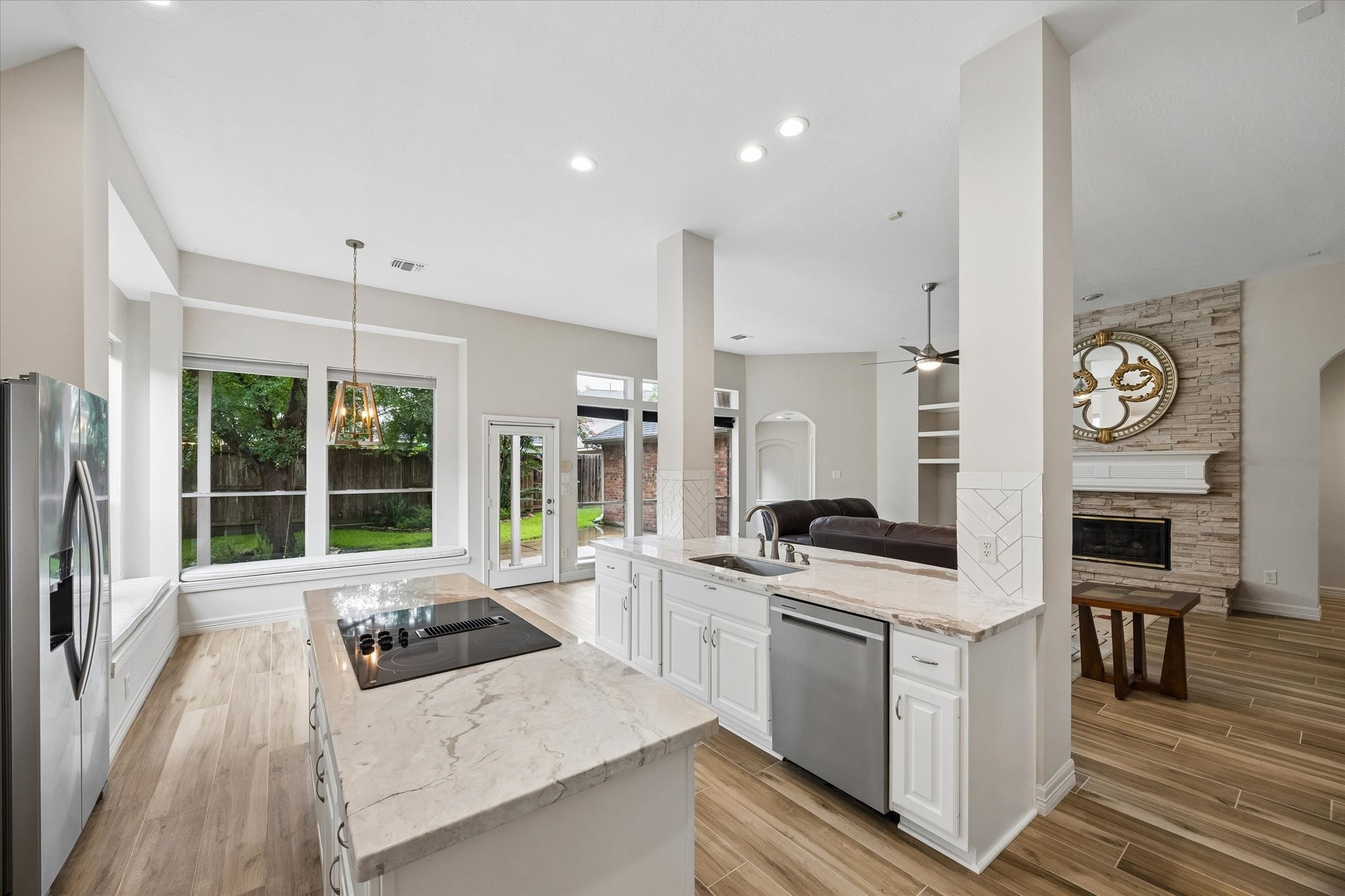 5306 Summerland Ridge Court Houston, TX 77041 - Photo 12 of 33 a kitchen with stainless steel appliances a stove a sink and white cabinets with wooden floor
