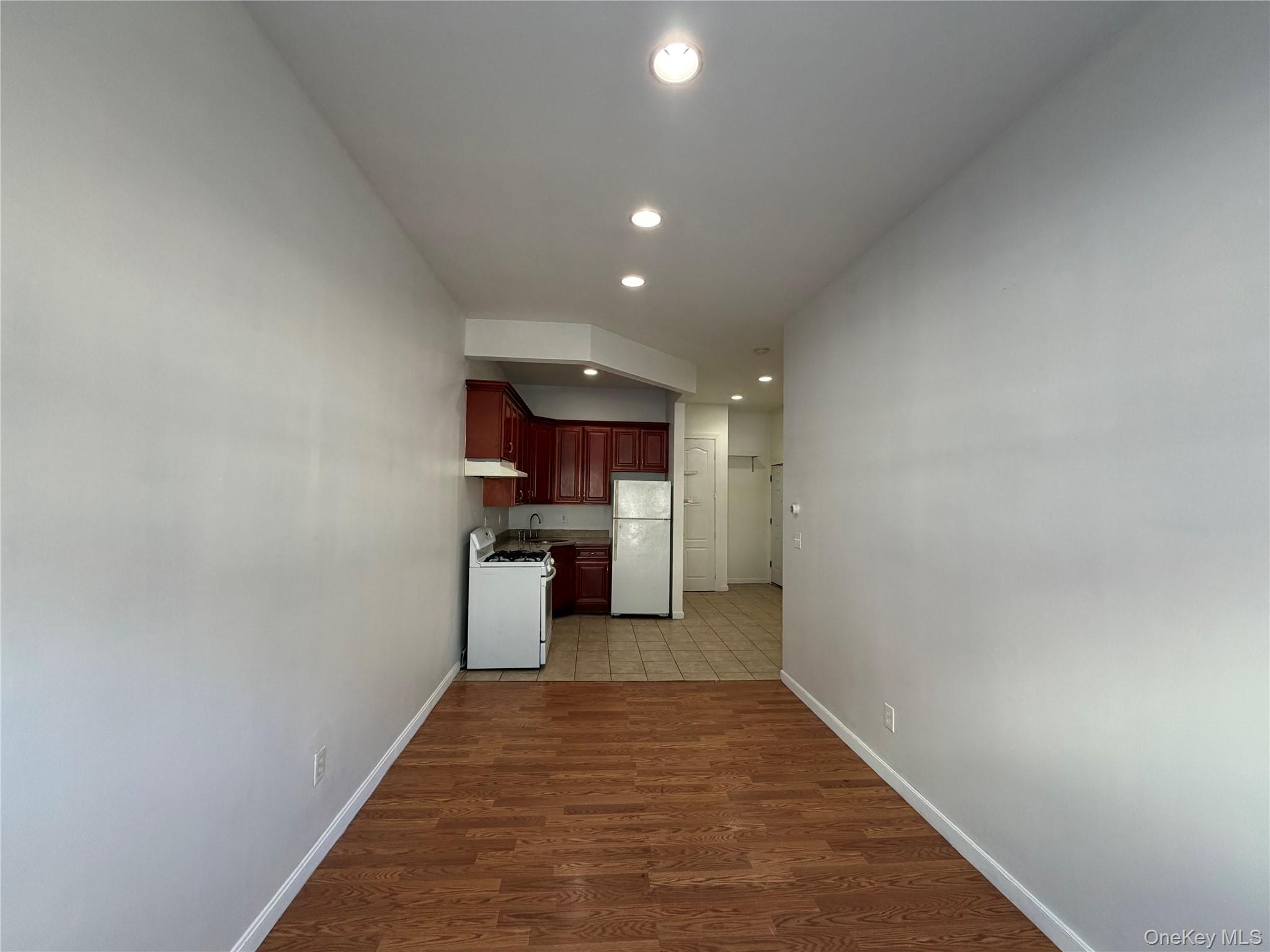 86-28 80th Street Queens, NY 11421 - Photo 3 of 5 a view of a hallway with a kitchen