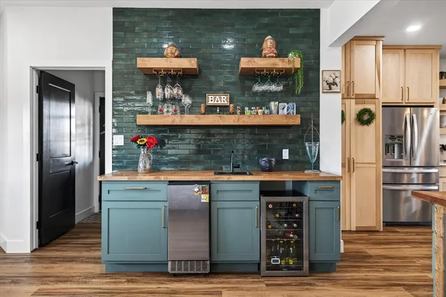 a kitchen with stainless steel appliances granite countertop a refrigerator and a stove