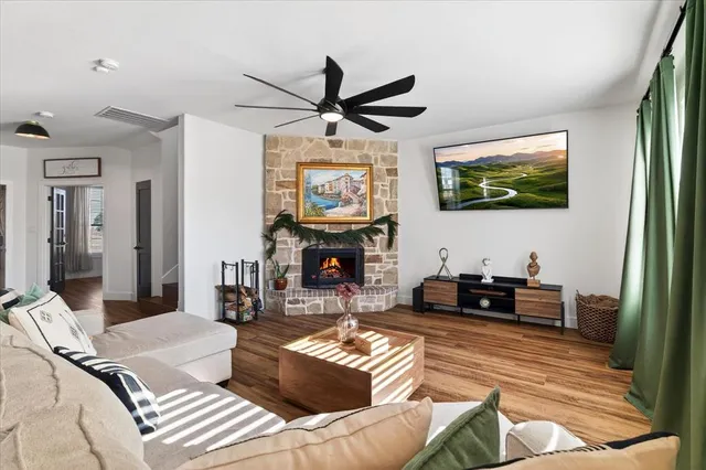 a living room with fireplace furniture and a flat screen tv