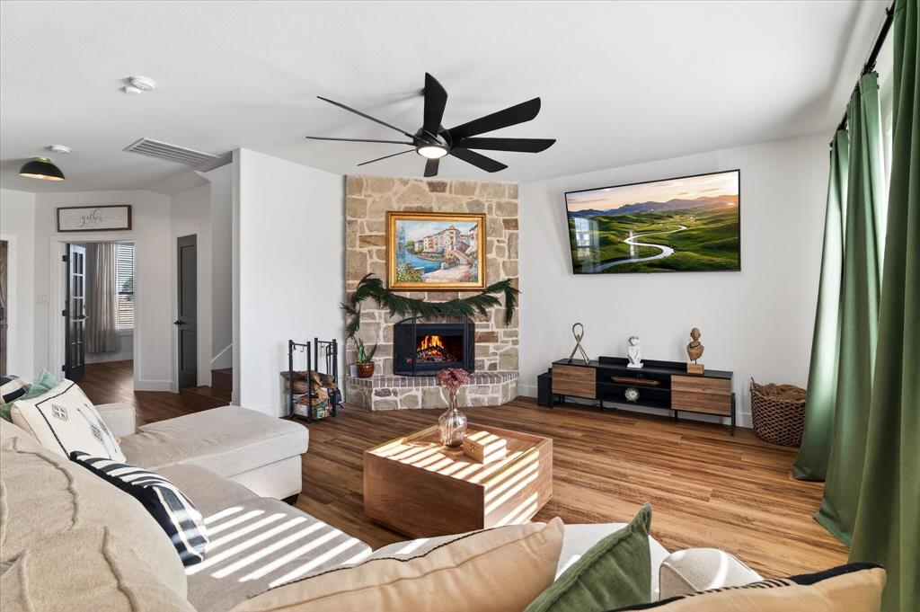 7675 Michael Road Sanger, TX 76266 - Photo 16 of 40 a living room with fireplace furniture and a flat screen tv