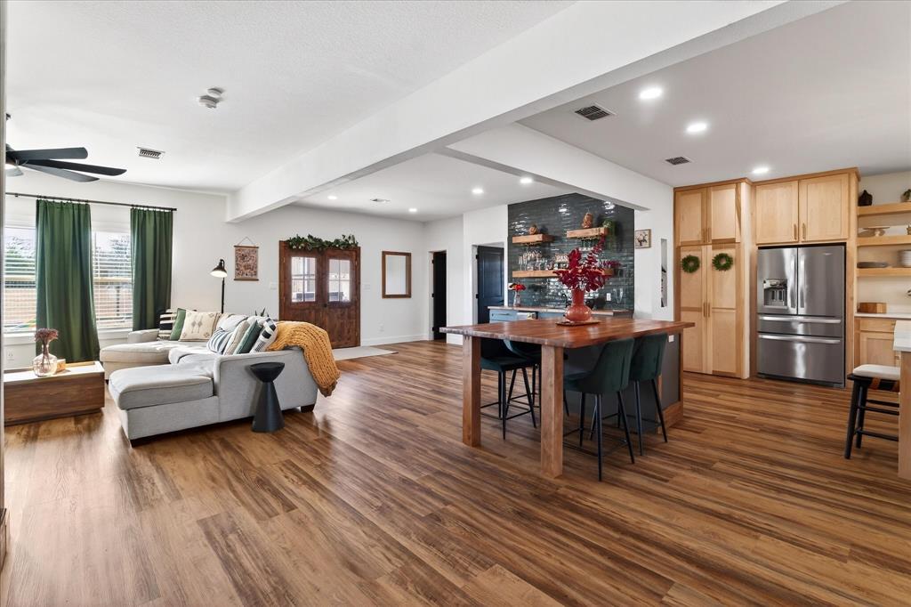 7675 Michael Road Sanger, TX 76266 - Photo 18 of 40 a living room with furniture dining table and wooden floors
