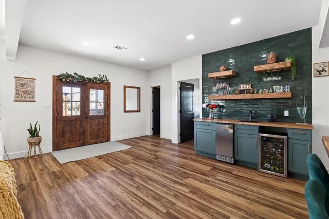 a open kitchen with stainless steel appliances granite countertop a refrigerator and stove top oven