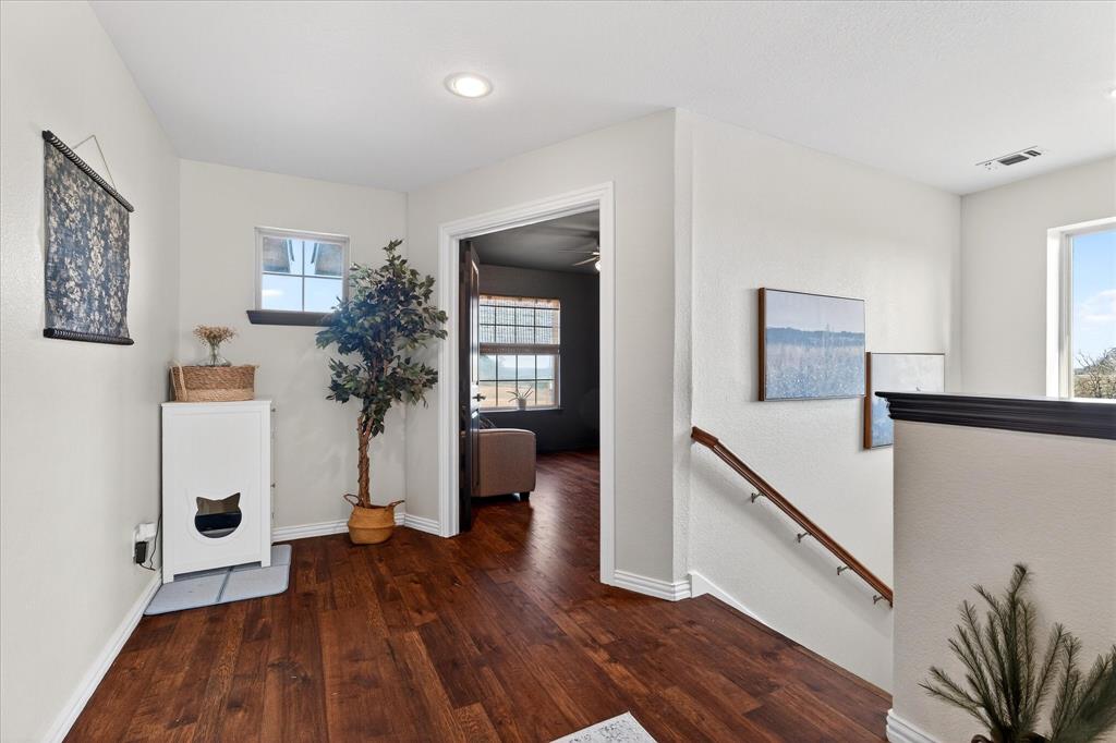 7675 Michael Road Sanger, TX 76266 - Photo 20 of 40 a view of a hallway with wooden floor and furniture