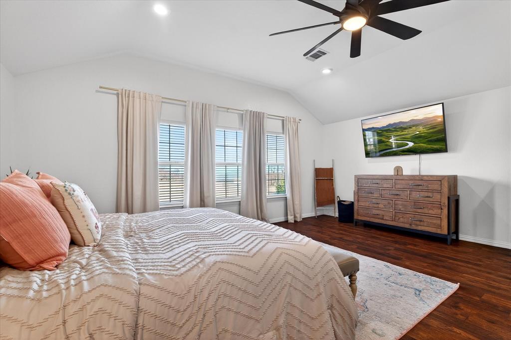 7675 Michael Road Sanger, TX 76266 - Photo 24 of 40 a bedroom with a bed and a flat screen tv