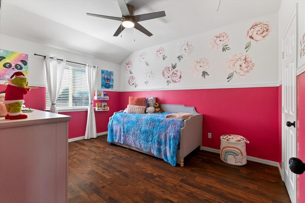 7675 Michael Road Sanger, TX 76266 - Photo 30 of 40 a bedroom with a bed and wooden floor