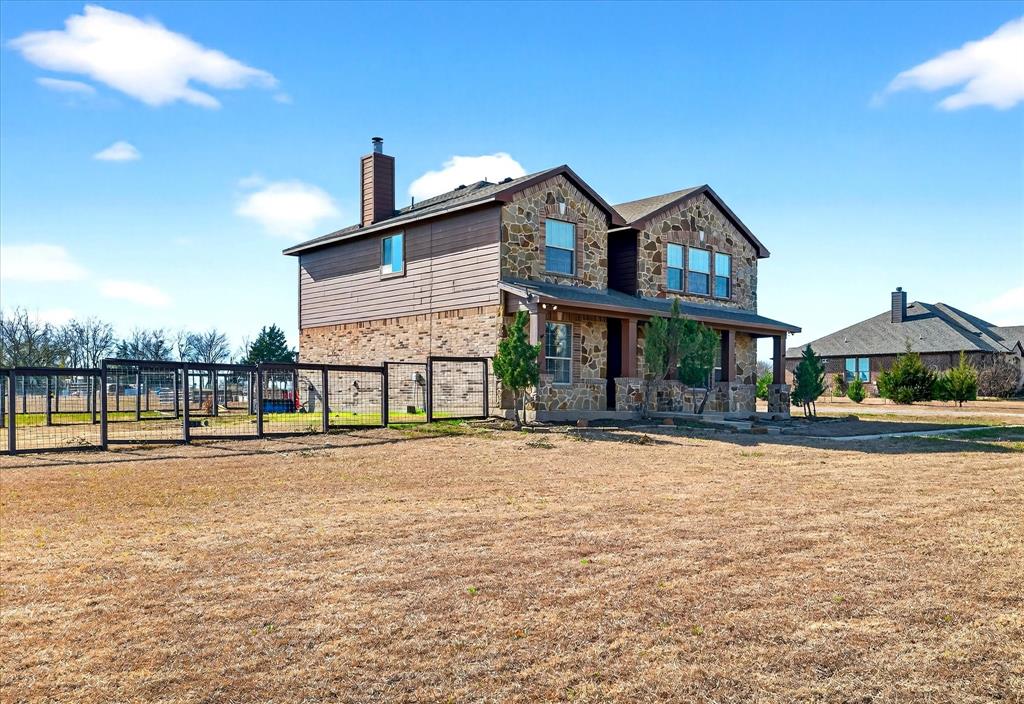 7675 Michael Road Sanger, TX 76266 - Photo 3 of 40 a front view of a house with a yard