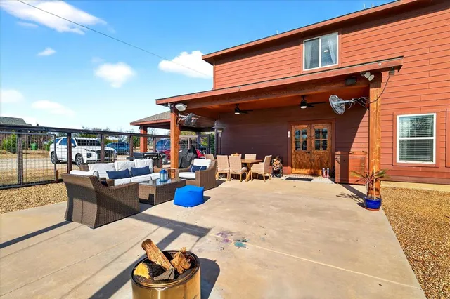 a view of a patio with dining table and chairs couches with wooden floor