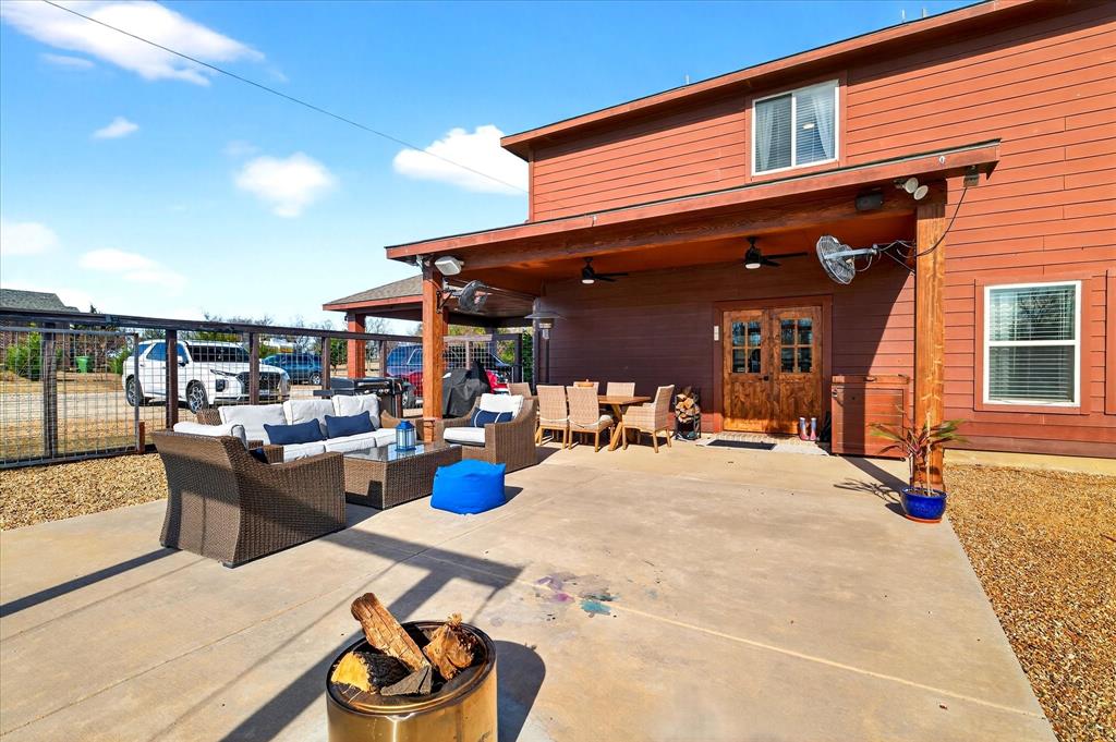 7675 Michael Road Sanger, TX 76266 - Photo 31 of 40 a view of a patio with dining table and chairs couches with wooden floor