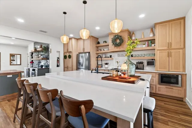 a dining room filled with furniture and a chandelier