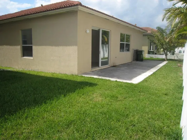 a view of a house with a backyard