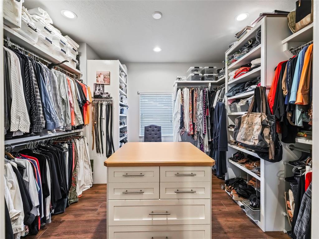 12943 Southeast Sunset Harbor Road Weirsdale, FL 32195 - Photo 37 of 87 a view of walk in closet with clothes and shoes