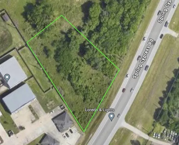 an aerial view of a residential houses with yard