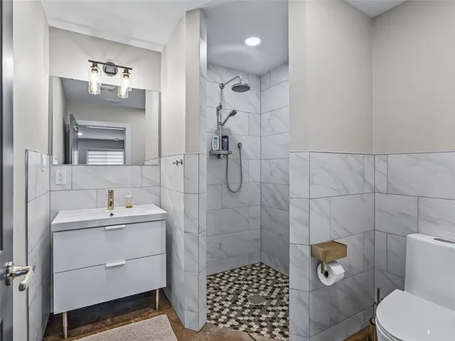 a kitchen with kitchen island a sink appliances and a dining table