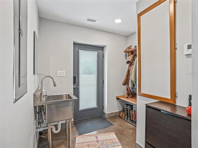 a living room with patio furniture and a flat screen tv