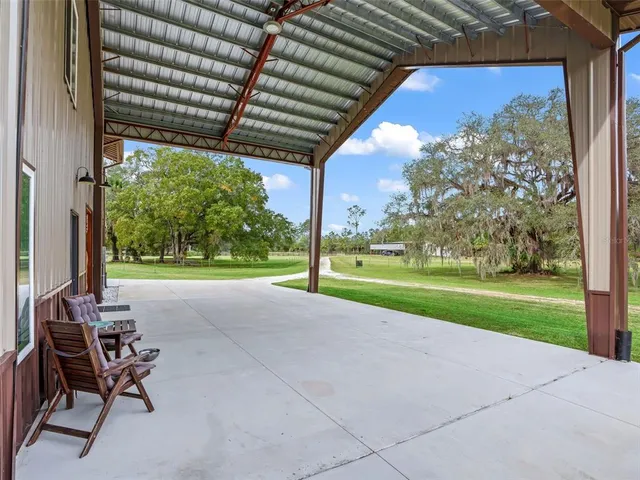 a view of yard with porch and furniture