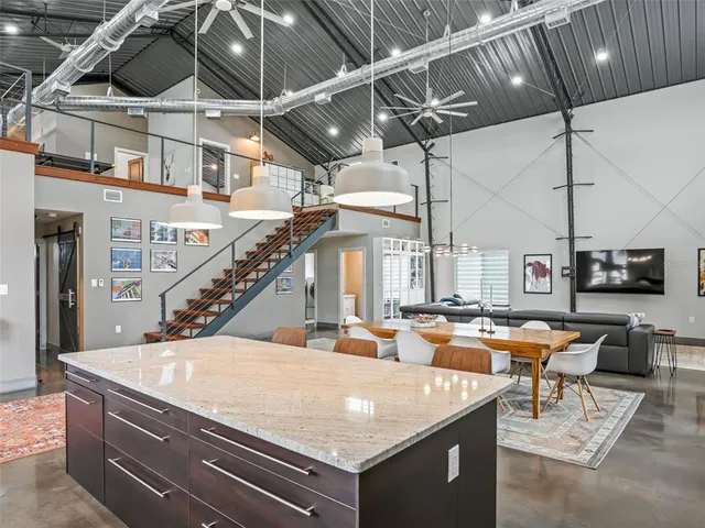 a dining room with furniture a chandelier and wooden floor