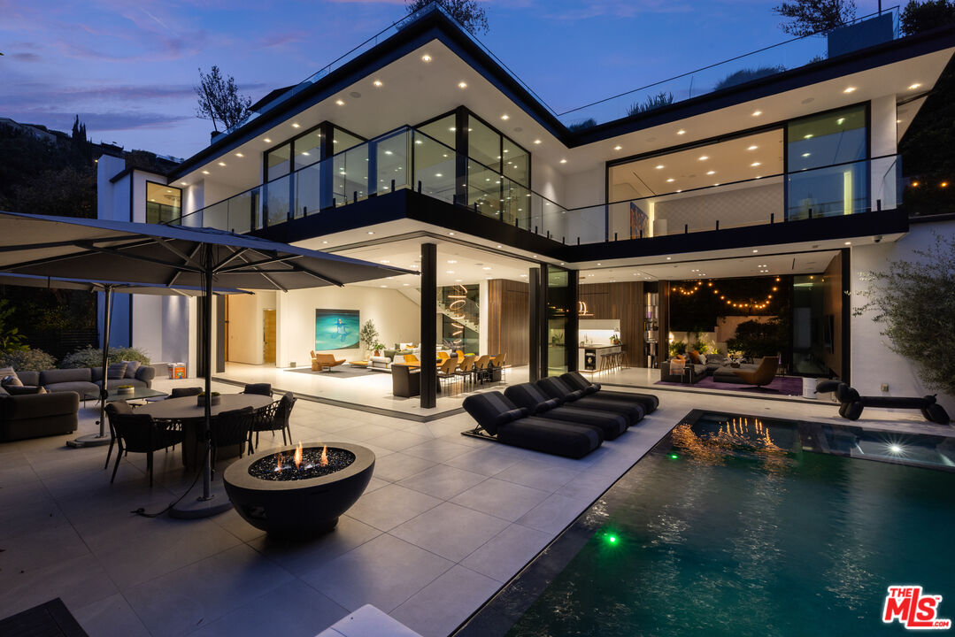 1488 Rising Glen Road Los Angeles, CA 90069 - Photo 1 of 37 a view of a patio with table and chairs potted plants and a fireplace