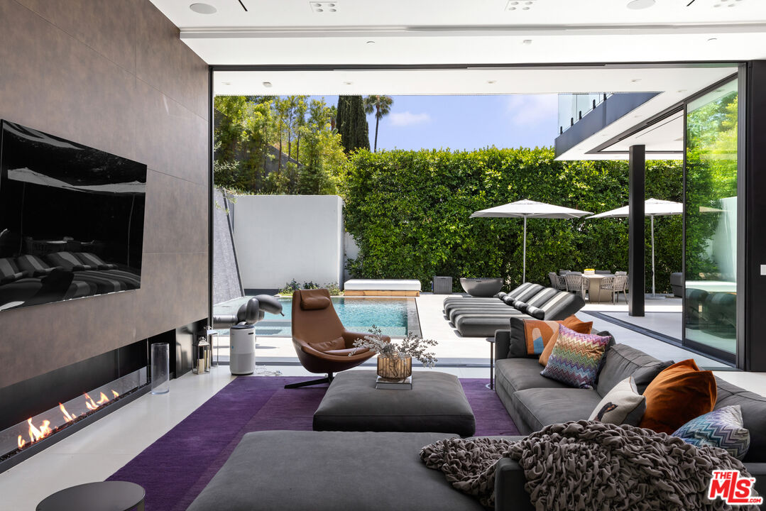 1488 Rising Glen Road Los Angeles, CA 90069 - Photo 11 of 37 a living room with furniture and a flat screen tv