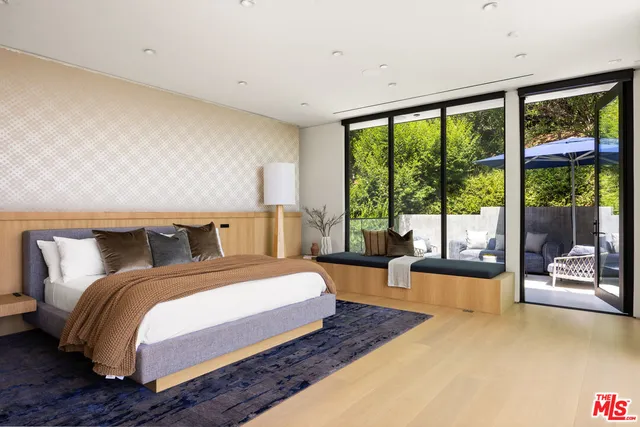 a bedroom with a large bed and a large window