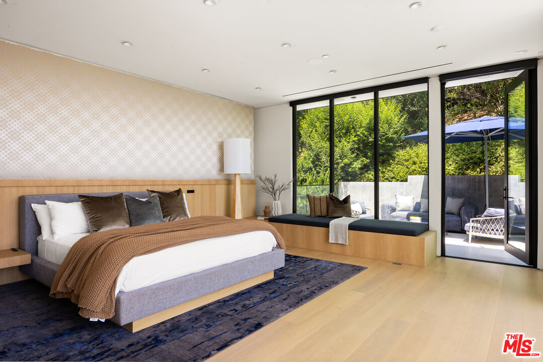 1488 Rising Glen Road Los Angeles, CA 90069 - Photo 16 of 37 a bedroom with a large bed and a large window