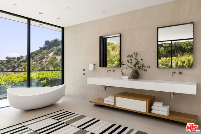 a living room with a window and a potted plant