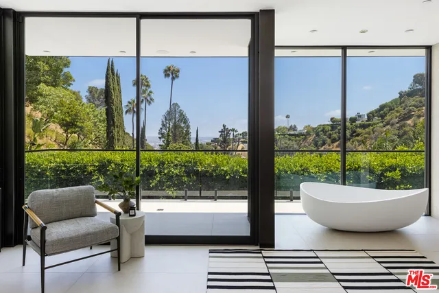 a living room with a couch a table and a potted plant