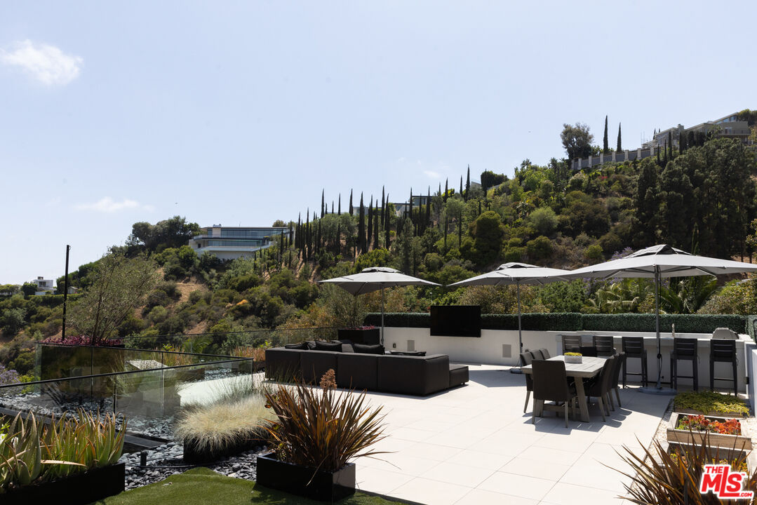 1488 Rising Glen Road Los Angeles, CA 90069 - Photo 23 of 37 a patio with couches and a fire pit