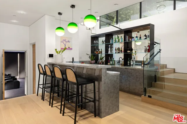 a dining hall with granite countertop kitchen island stainless steel appliances a dining table and chairs