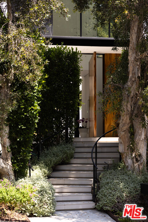 1488 Rising Glen Road Los Angeles, CA 90069 - Photo 3 of 37 a front view of a house with a yard