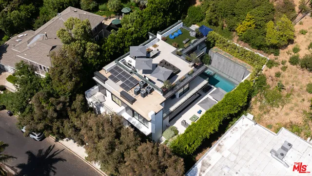 a view of a house with a yard and garden