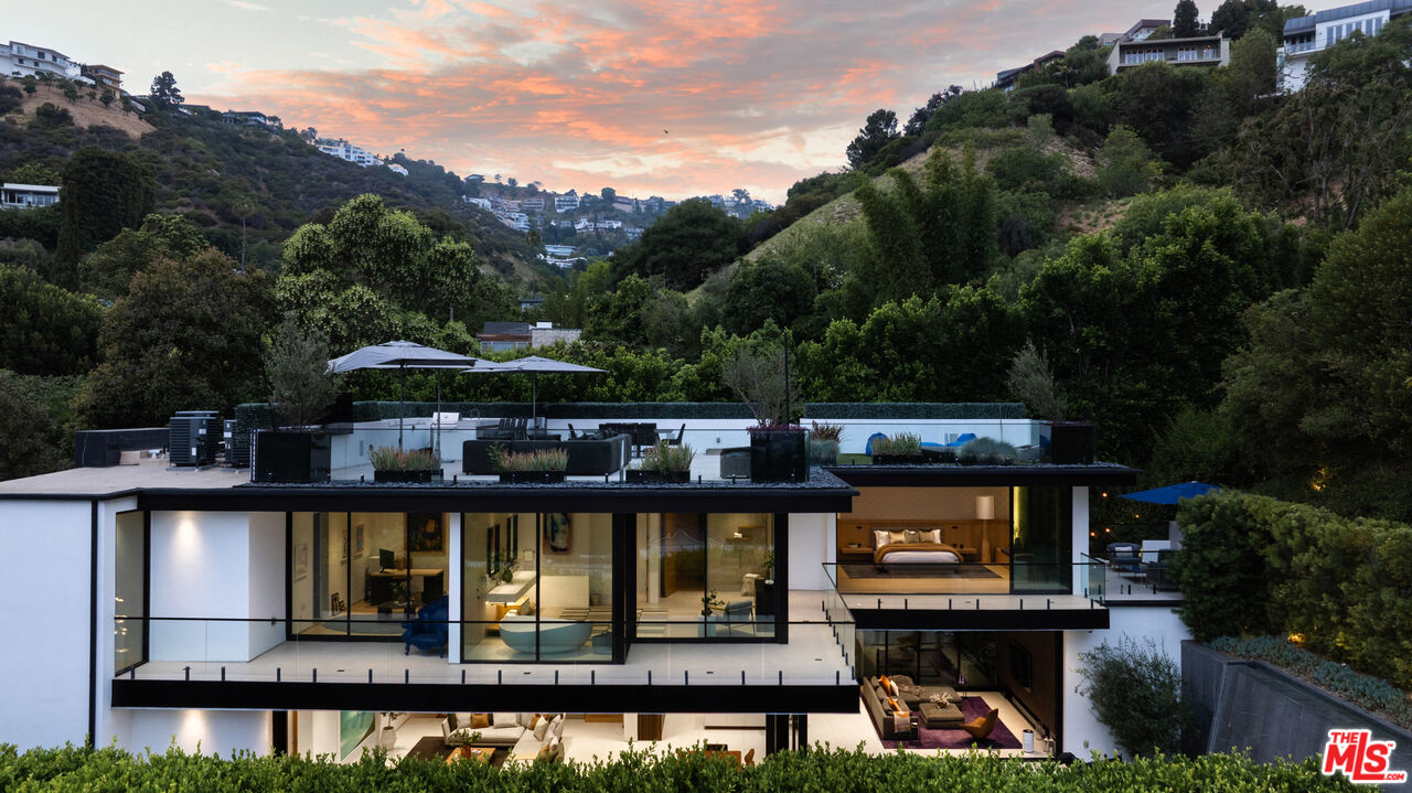 1488 Rising Glen Road Los Angeles, CA 90069 - Photo 33 of 37 aerial view of a house with swimming pool and large trees
