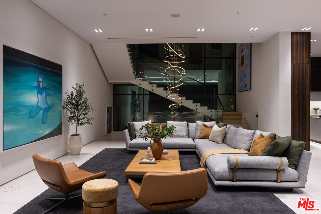 1488 Rising Glen Road Los Angeles, CA 90069 - Photo 36 of 37 a living room with furniture and a wooden floor