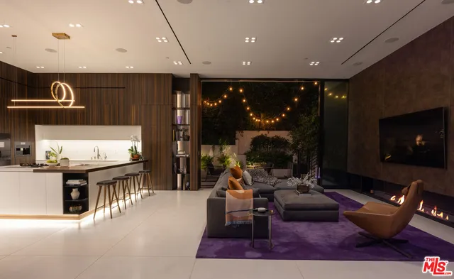 a living room with furniture a rug and a fireplace