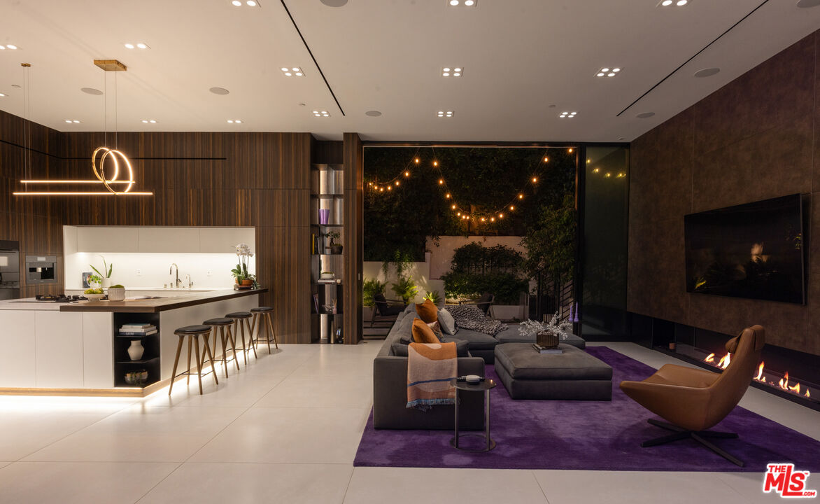 1488 Rising Glen Road Los Angeles, CA 90069 - Photo 37 of 37 a living room with furniture a rug and a fireplace