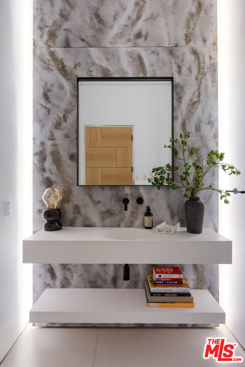 1488 Rising Glen Road Los Angeles, CA 90069 - Photo 5 of 37 a bathroom with a sink and a mirror