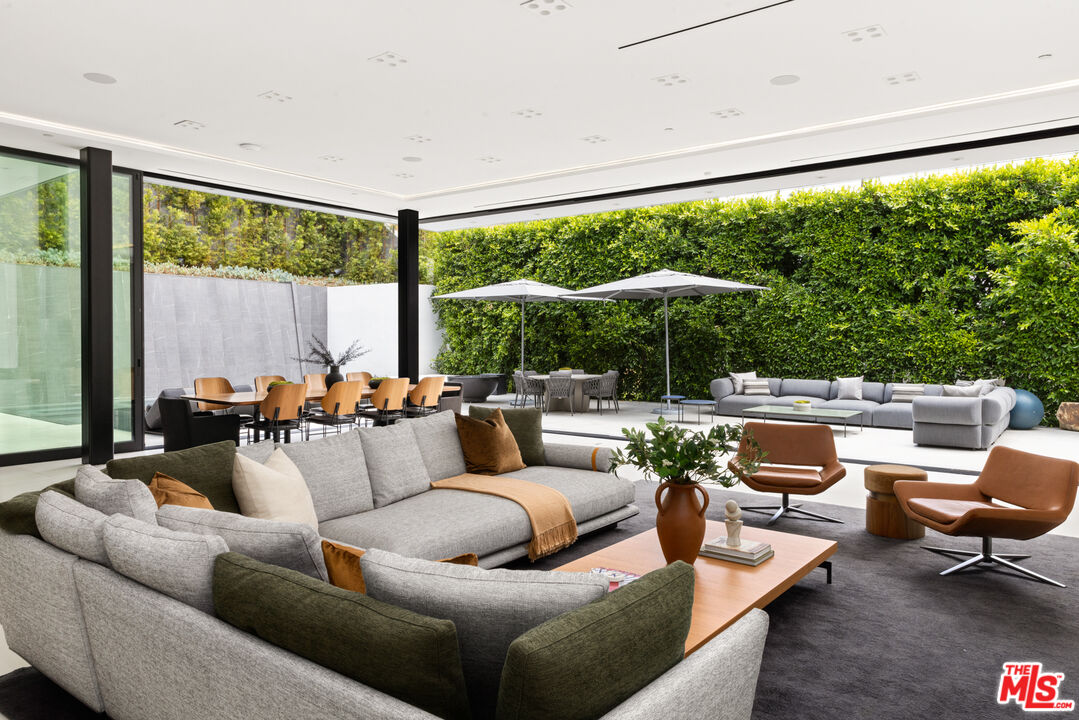 1488 Rising Glen Road Los Angeles, CA 90069 - Photo 7 of 37 a living room with furniture and a large window