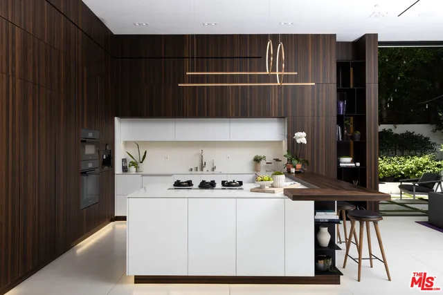 a kitchen with a sink a table and chairs