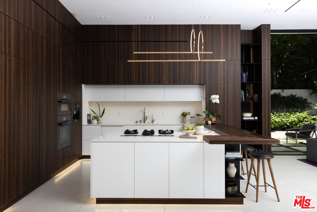 1488 Rising Glen Road Los Angeles, CA 90069 - Photo 9 of 37 a kitchen with a sink a table and chairs