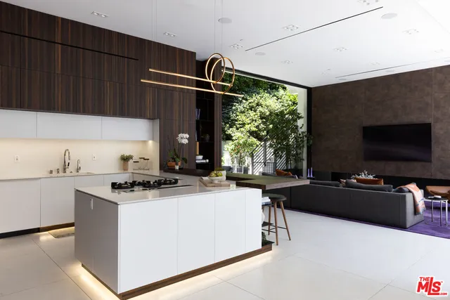 a kitchen with kitchen island a stove a sink and a microwave