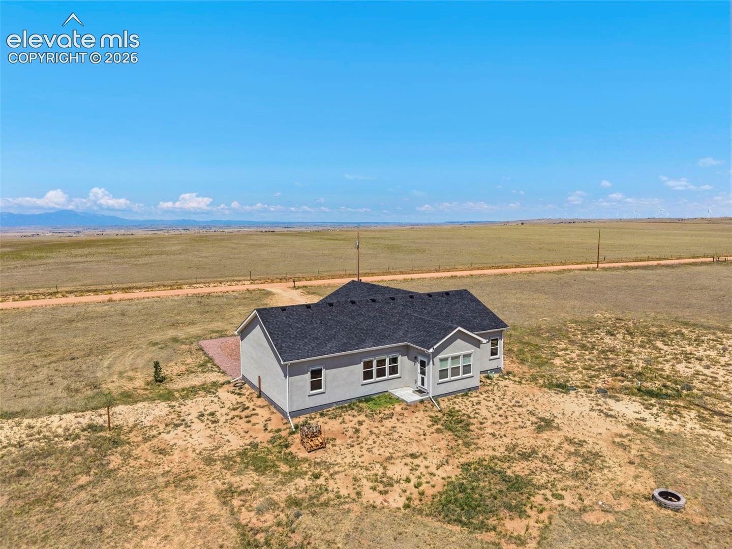 3955 North Yoder Road Yoder, CO 80864 - Photo 31 of 38 Single-story residence featuring light gray siding, dark shingle roofing, and white window trim