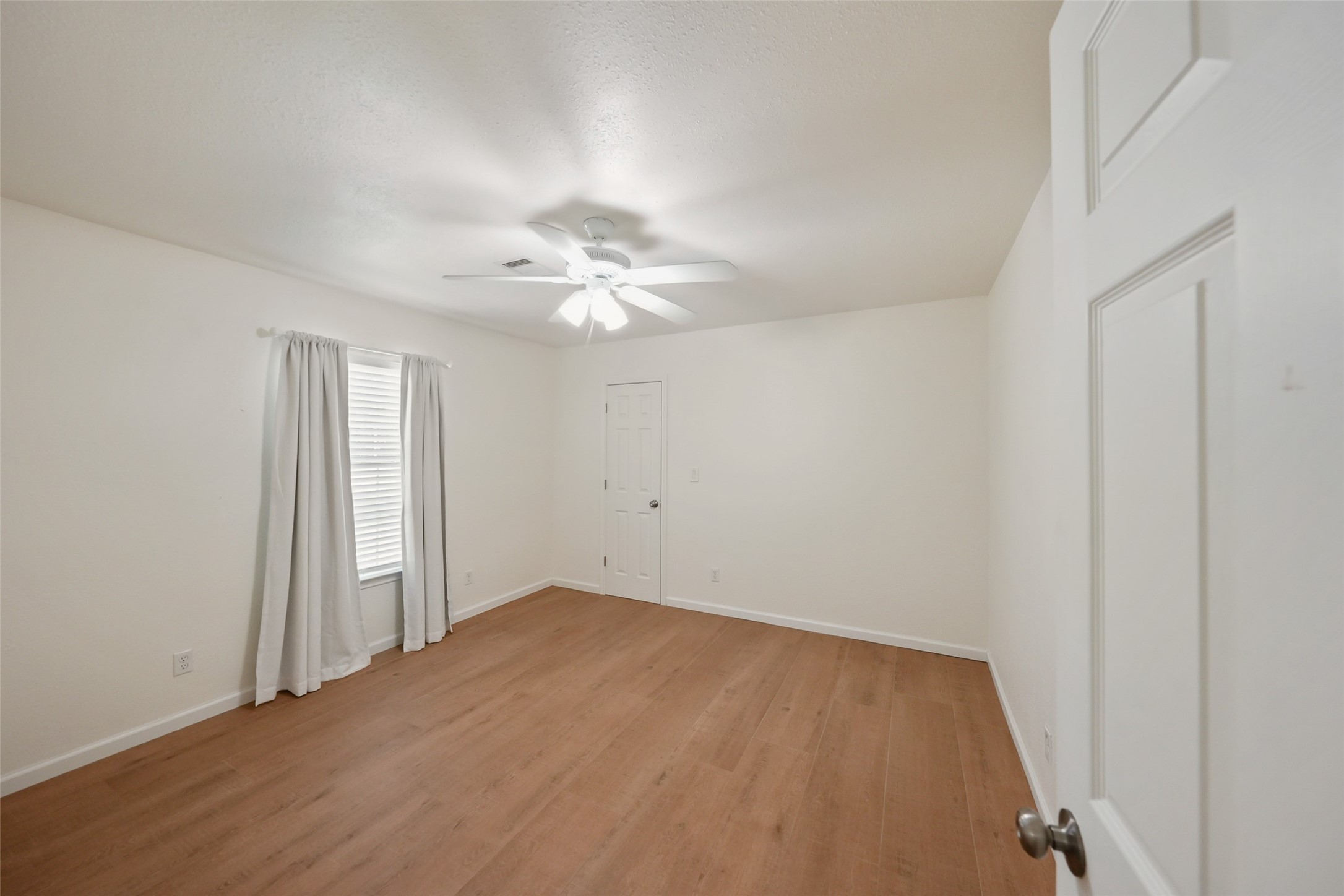 19635 Kermier Road Waller, TX 77484 - Photo 15 of 27 Comfortable secondary bedroom with a ceiling fan, closet, and natural light.