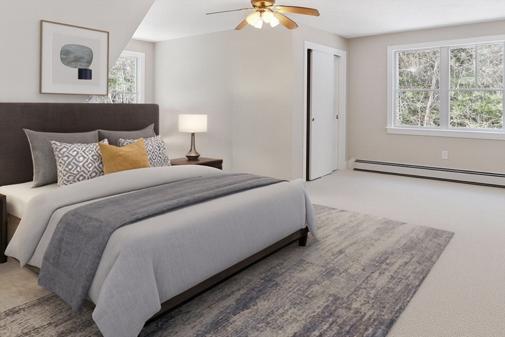 232 Sherbert Road Ashburnham, MA 01430 - Photo 23 of 42 a bedroom with a bed and a chandelier