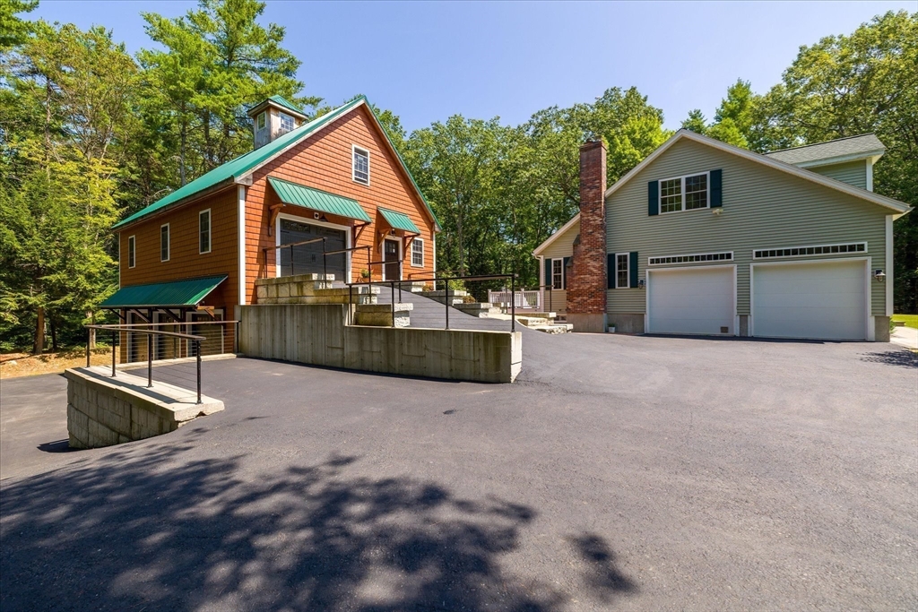 232 Sherbert Road Ashburnham, MA 01430 - Photo 27 of 42 a front view of house with yard and trees in the background