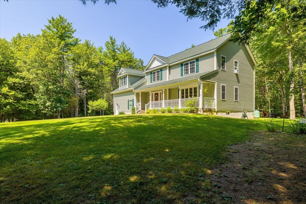 232 Sherbert Road Ashburnham, MA 01430 - Photo 5 of 42 a front view of a house with a garden