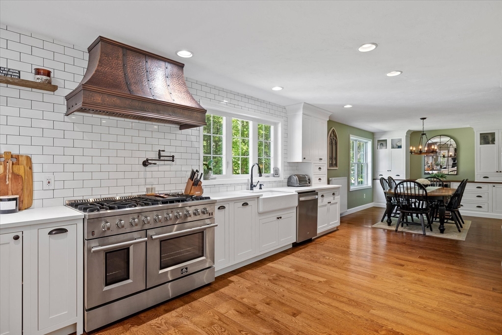 232 Sherbert Road Ashburnham, MA 01430 - Photo 9 of 42 a kitchen with stainless steel appliances a stove a sink a oven a dining table and chairs